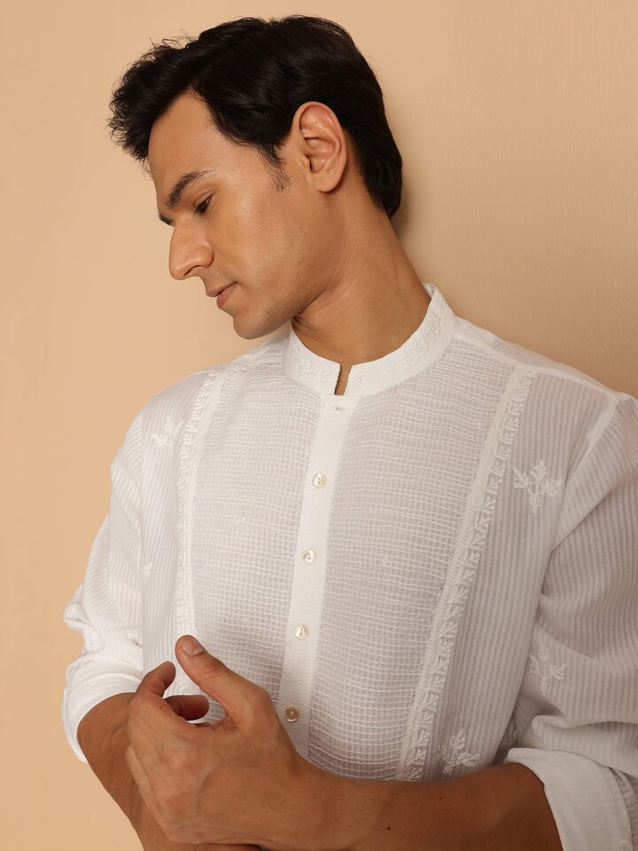 Side lifestyle view of white cotton Chikankari kurta capturing full-length profile and straight cut