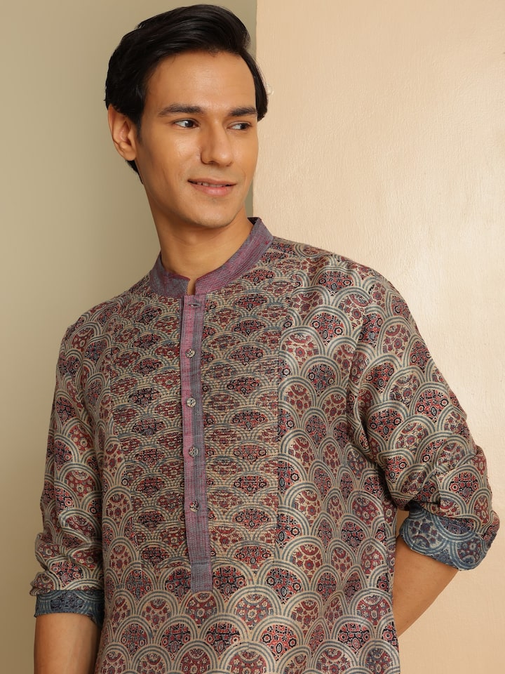 Angled lifestyle view highlighting Ajrakh motifs and silk sheen on indigo kurta