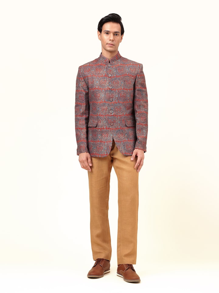 Lifestyle view of indigo silk Ajrakh block printed Bandhgala jacket styled with white kurta and trousers