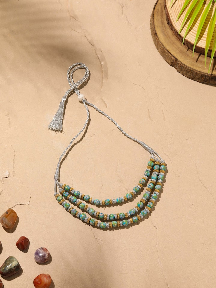 Angled view of Blue Pottery Long Necklace showcasing detailed blue pottery design and craftsmanship.