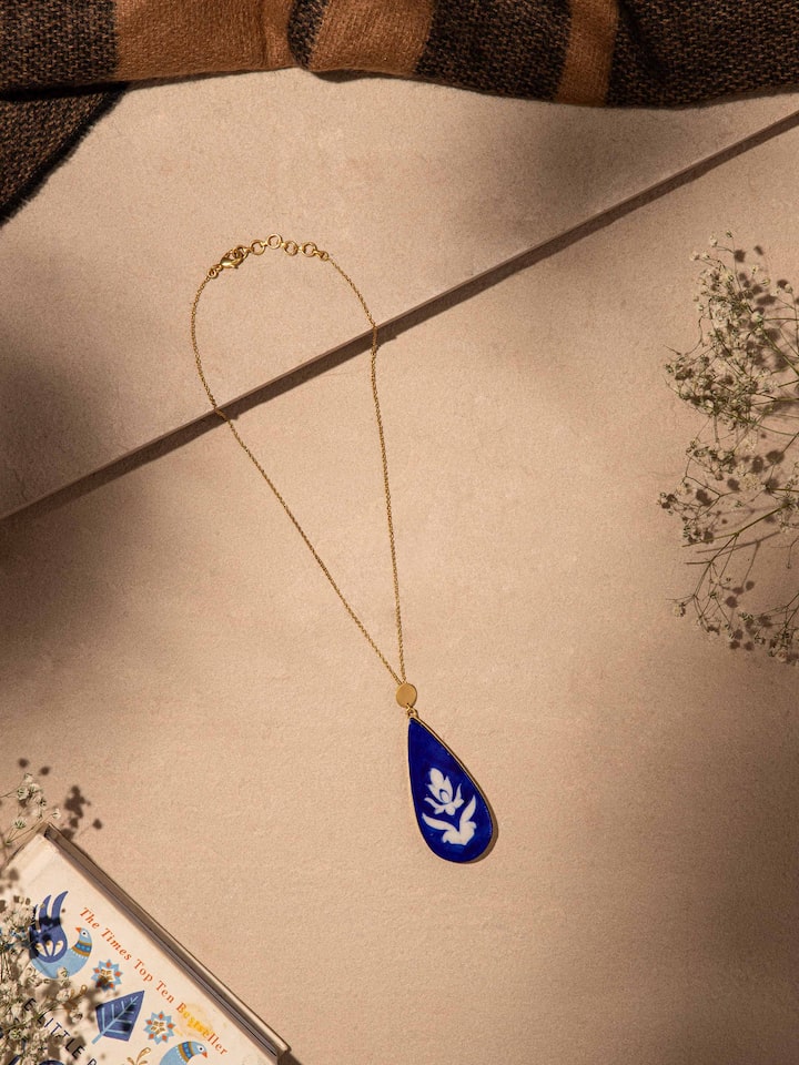 Close-up view of Blue Pottery Pendant & Chain featuring intricate blue pottery designs and fine chain detailing.