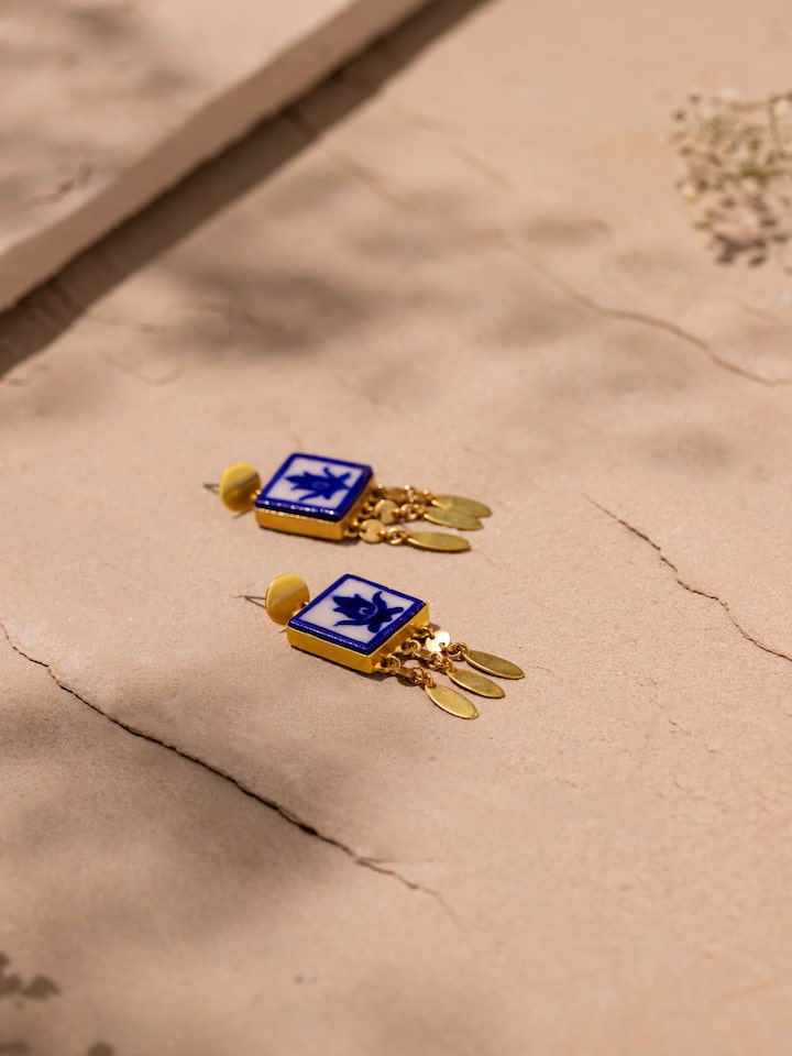 Detailed view of blue pottery drop earrings showing their unique glaze and finish.