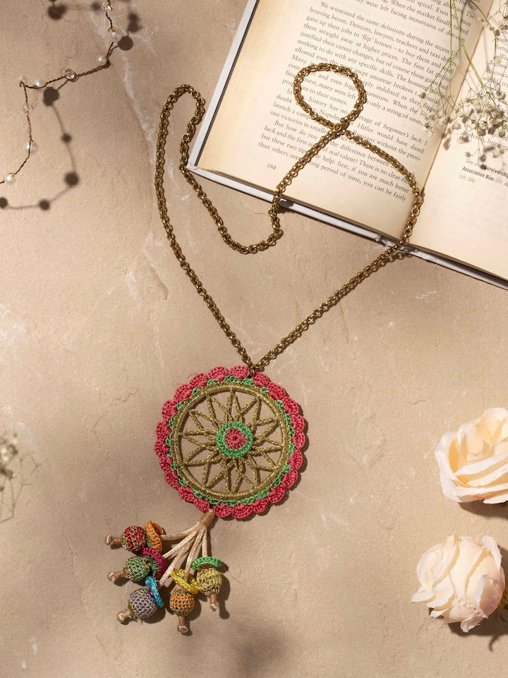 Styled detail view of Crochet Pendant & Chain worn around the neck, shown in an alternate styled shot