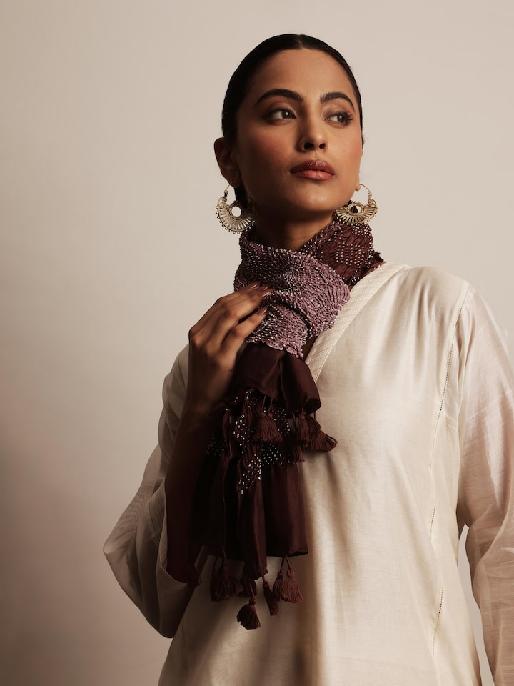 Lifestyle view showing the wine Bandhani stole draped over a traditional outfit.