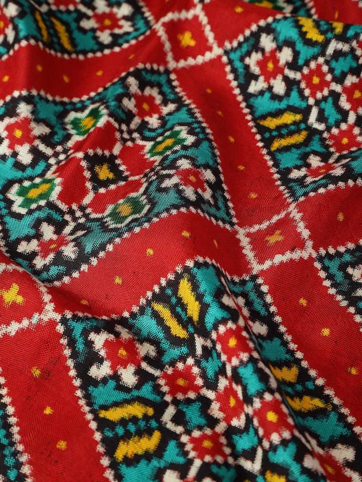 Detail view of red silk Patola dupatta capturing woven design and silk sheen