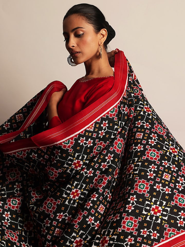 Angled close-up of Black Silk Patola Dupatta highlighting silk texture and traditional motifs.