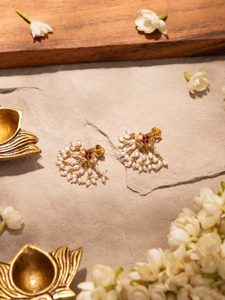 Styled detail view of Guttapusalu Silver Drop Earrings worn on the ear, shown in an alternate styled shot