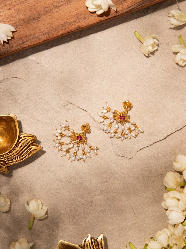 Styled detail view of Guttapusalu Silver Drop Earrings worn on the ear, shown in another styled shot