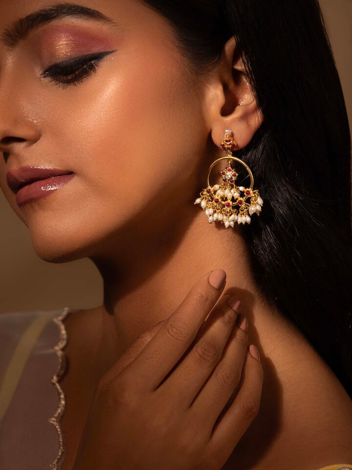Lifestyle shot of Guttapusalu silver earrings showing elegant drop length and pearl accents.