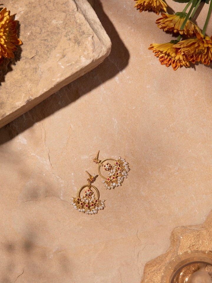 Overhead view of Guttapusalu drop earrings displaying full form and traditional craftsmanship.