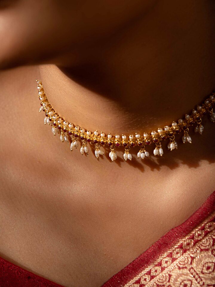 Styled detail view of Guttapusalu Silver Choker worn around the neck, shown in another styled shot
