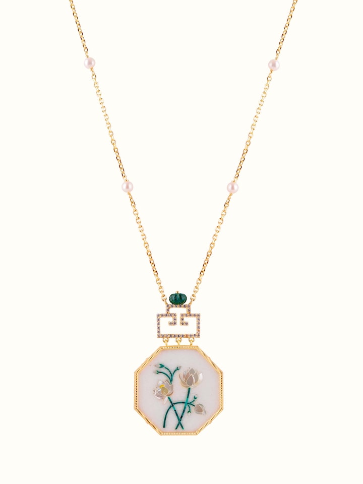 Front view of Pacchikari silver pendant with matching chain, showcasing intricate design