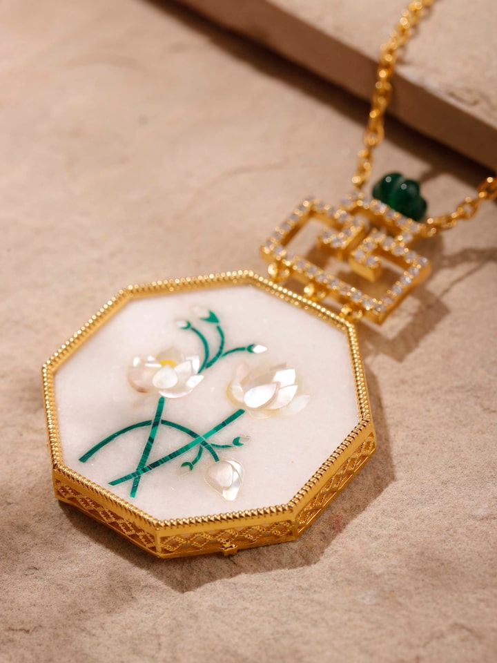 Close-up detail shot of Pacchikari pendant craftsmanship and silverwork