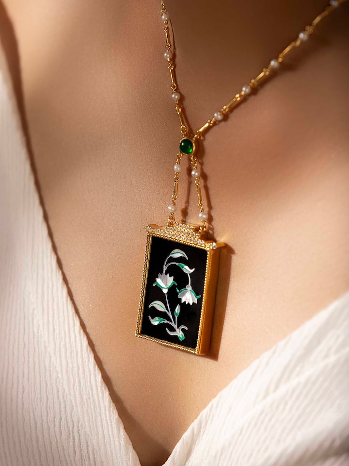 Side view of Pacchikari silver pendant and chain highlighting the detailed craftsmanship and style.