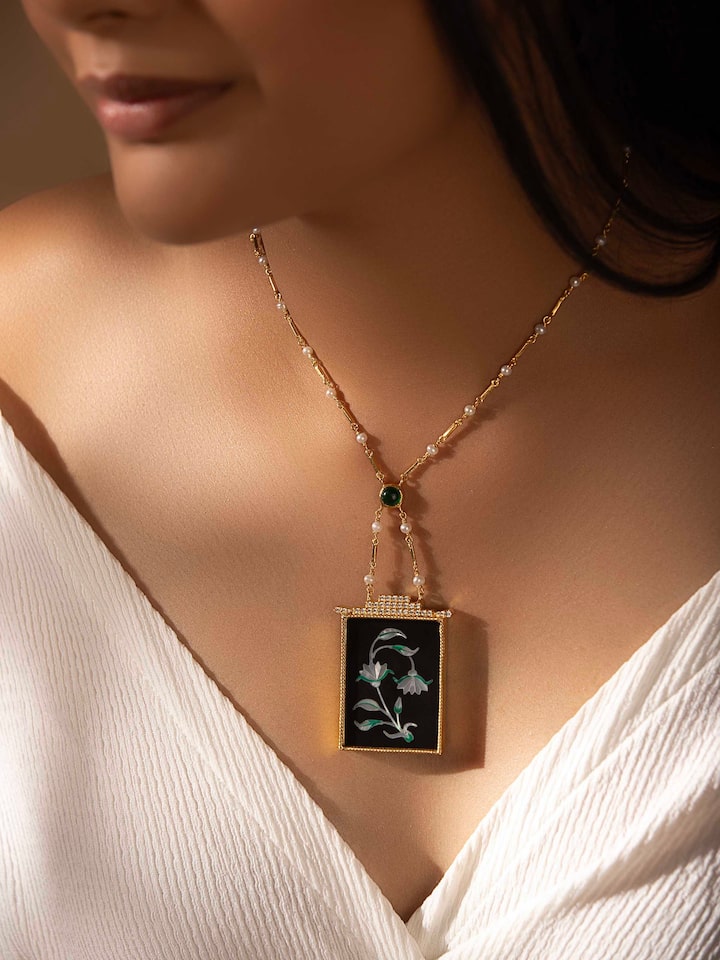 Angled view of Pacchikari silver pendant and chain showcasing its fine design and elegant finish.