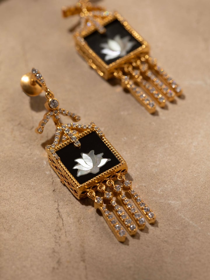 Detail close-up of Parchinkari silver drop earrings revealing fine craftsmanship and floral inlay artistry.