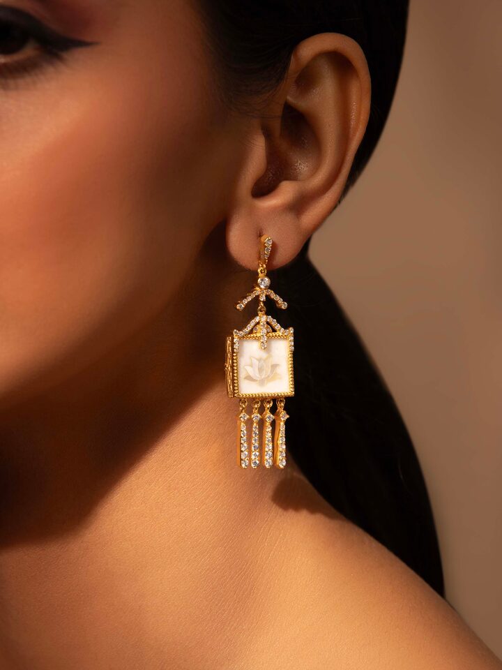Side view of Pacchikari Silver Drop Earrings showcasing the unique design and silver detailing.