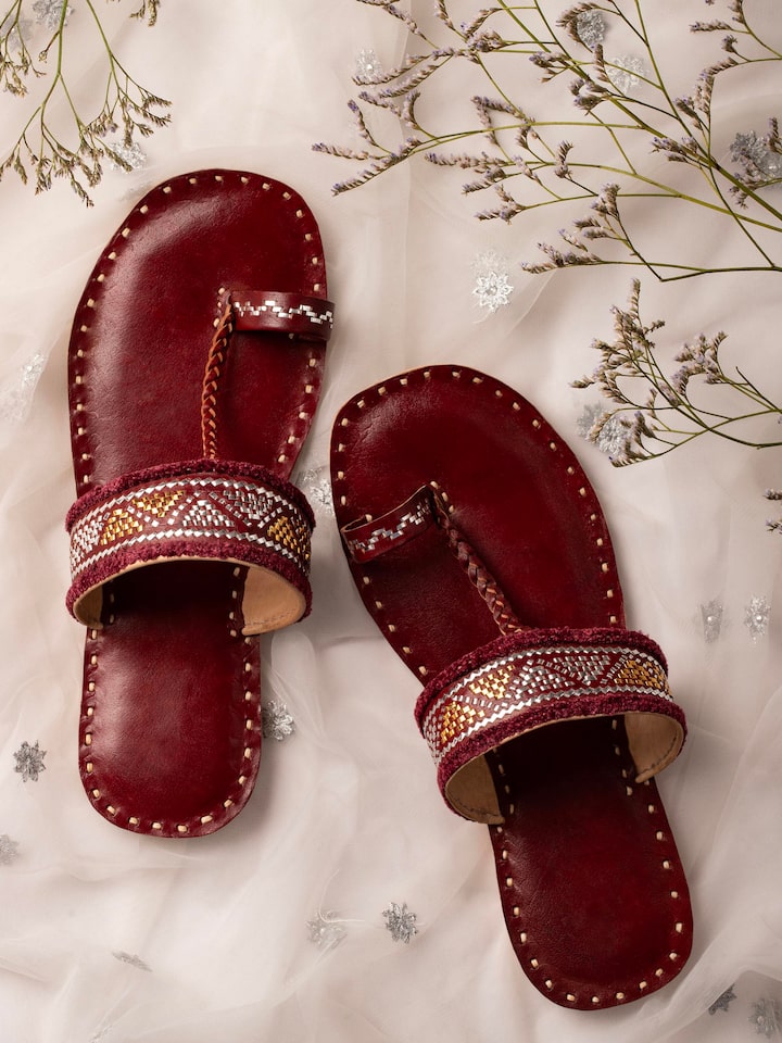 Side view of Tan leather kutch stitched flats highlighting design details