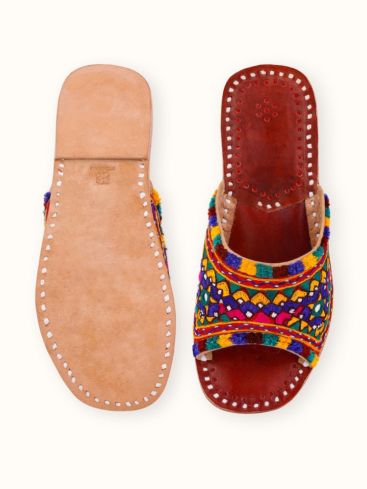 Detailed view of tan leather kutch embroidered slides emphasizing the kutch work