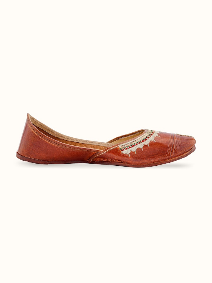 Back view of tan leather haryana juttis showing overall design and quality