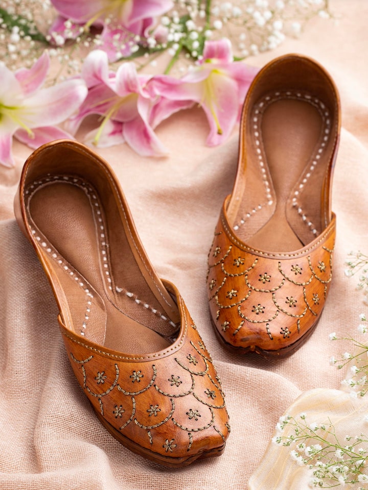 Side view of Mustard Leather Haryana Juttis highlighting the curved toe and handcrafted details.
