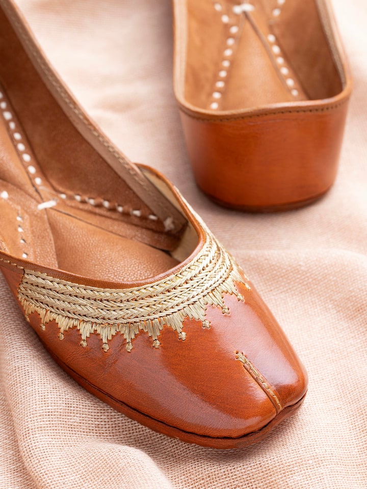 Detailed view of Mustard leather haryana juttis highlighting embroidery pattern