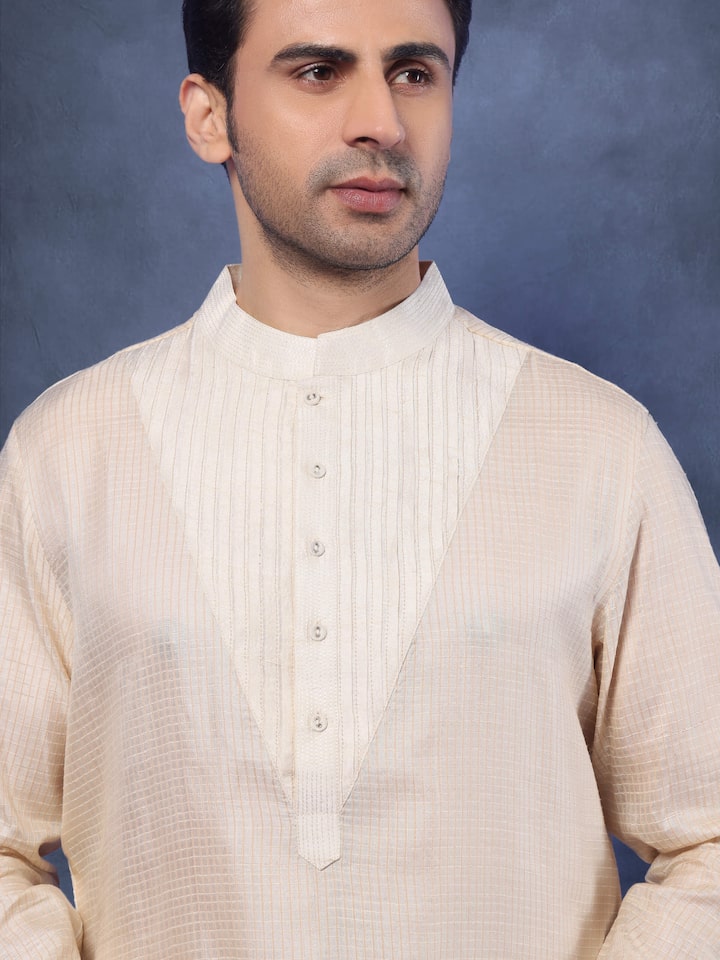Detail shot of neckline and front placket of beige Tussar silk kurta showcasing the fine texture.