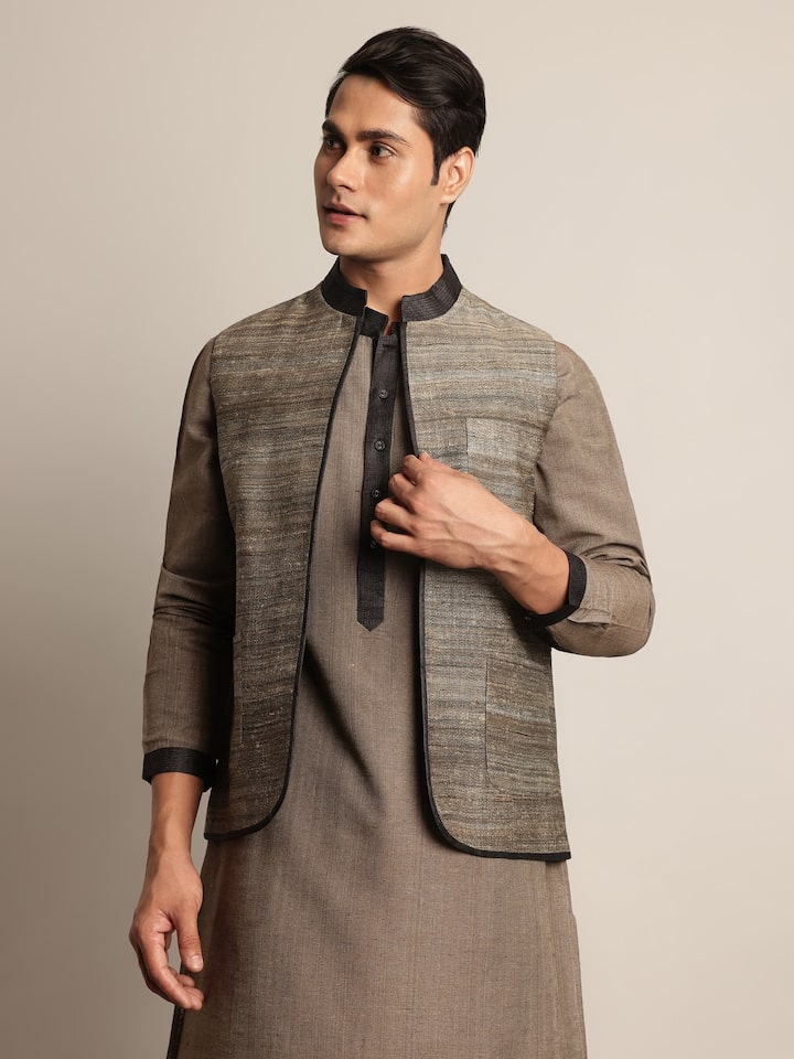 Side lifestyle view of light grey Tussar jacket showing its tailored fit and elegant drape.