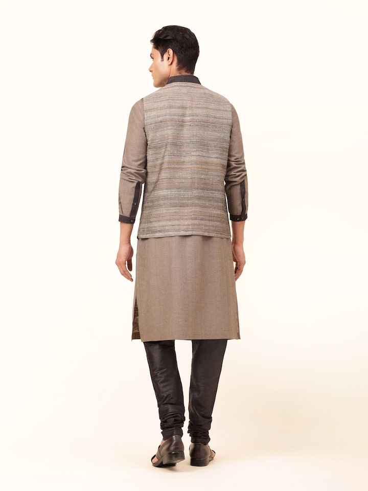 Back view of sleeveless Tussar silk jacket in light grey showing simple and clean finish.