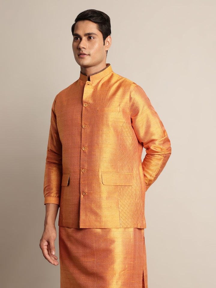 Angled view of mustard mulberry silk sleeveless jacket highlighting fabric sheen and cut