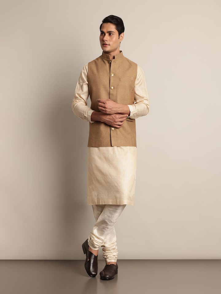 Lifestyle view of model wearing brown silk jacket with Indo-western styling