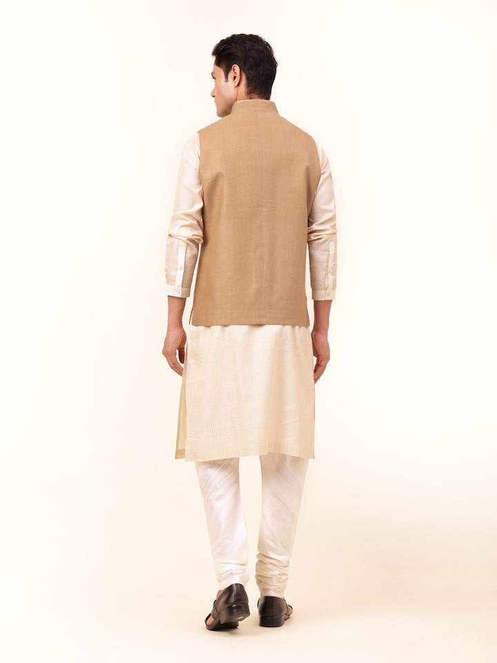 Back view of brown Tussar jacket highlighting fabric fall and stitching
