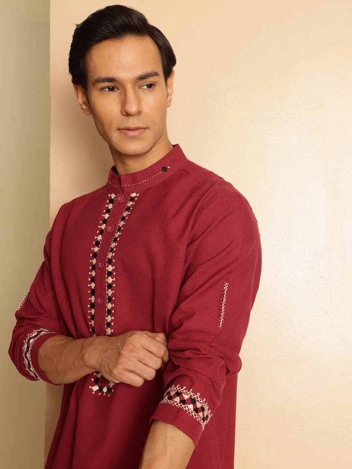 Side lifestyle view of embroidered long kurta showcasing sleeve detail and straight hem