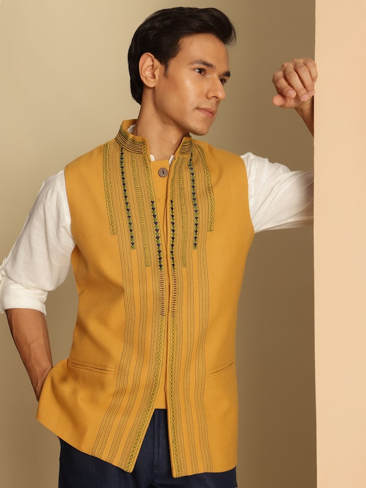 Angled pose of model in Mustard Soof Embroidered Jacket emphasizing hand-stitched detailing and collar design.