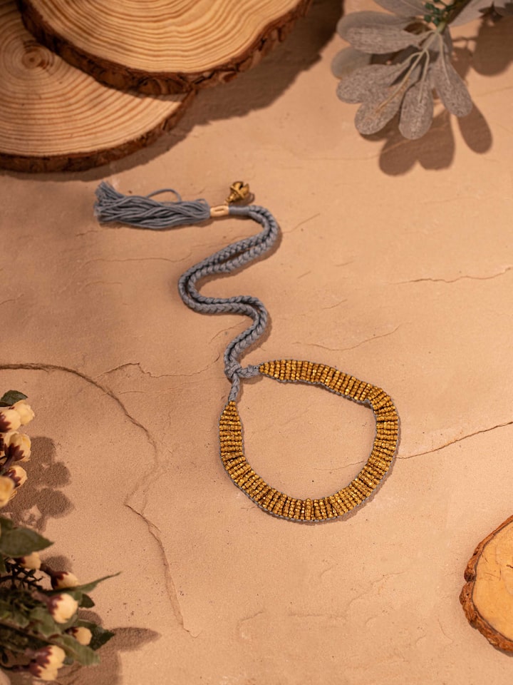 Styled detail view of Dhokra Long Necklace worn around the neck, shown in an alternate styled shot