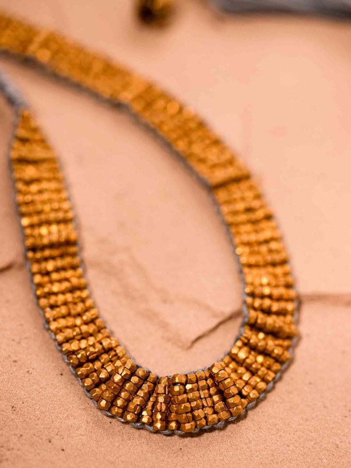 Detail view of Dhokra Long Necklace highlighting the stone setting and metalwork detail