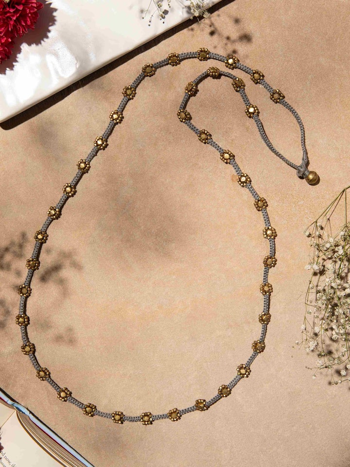 Side view of Dhokra Long Necklace highlighting the detailed Dhokra metalwork and design elements.