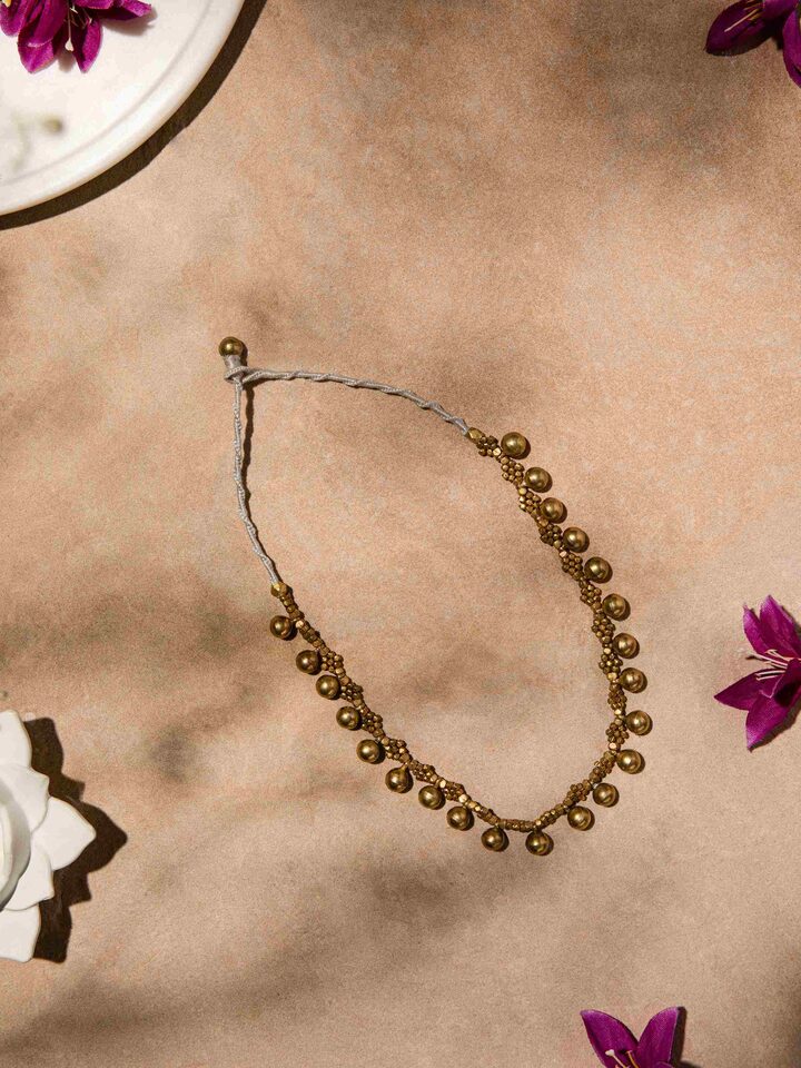 Side view of Dhokra Choker highlighting the detailed Dhokra designs and the elegant choker style.