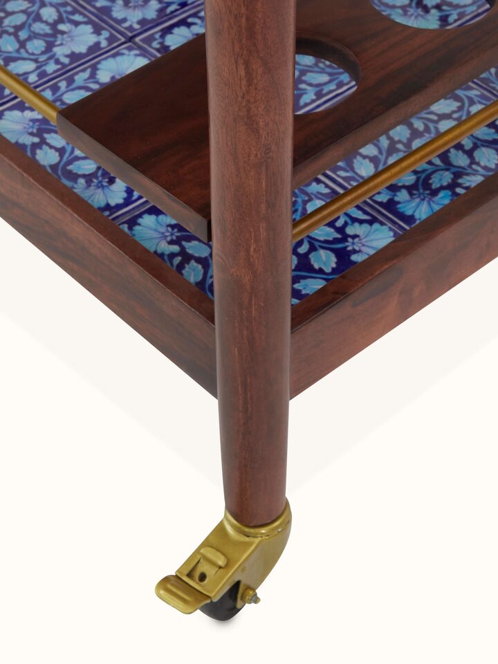 Back view of the Sheesham wood bar trolley with blue pottery, showing the overall design and functional features of the trolley