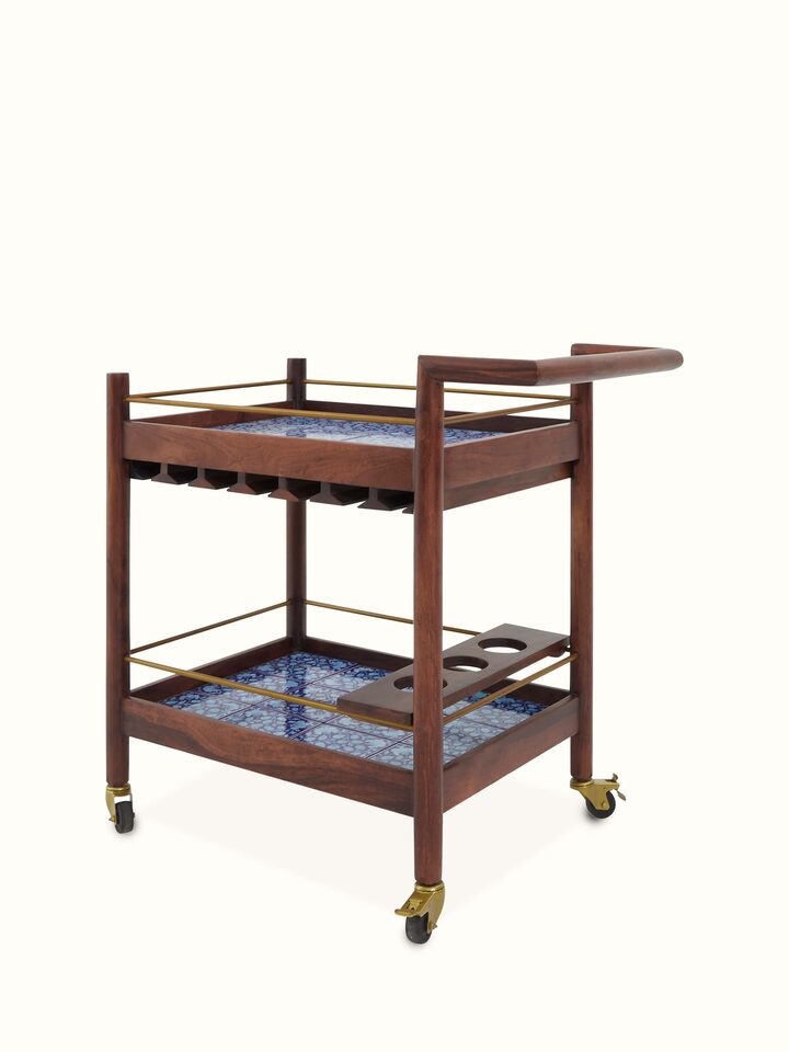 Angled view of the Sheesham wood blue pottery bar trolley, highlighting the combination of traditional woodwork and decorative pottery elements