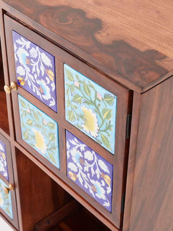 Detail shot of Sheesham wood blue pottery wall shelf (2 doors) showcasing intricate carvings
