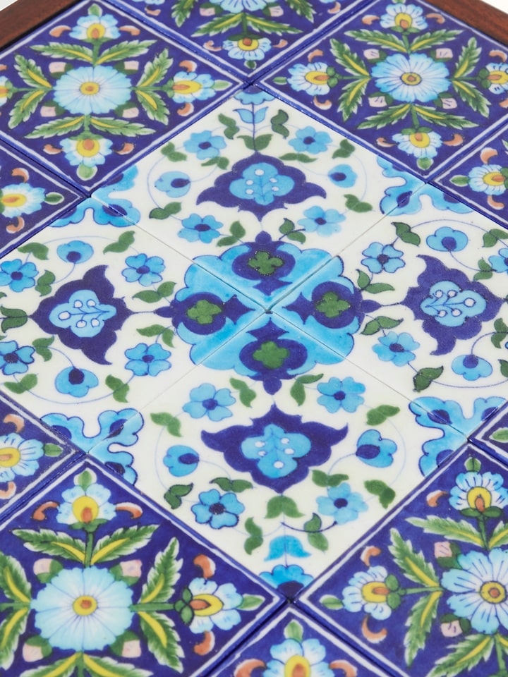 Back view of Sheesham wood side table with blue pottery top, revealing the structural design and craftsmanship.
