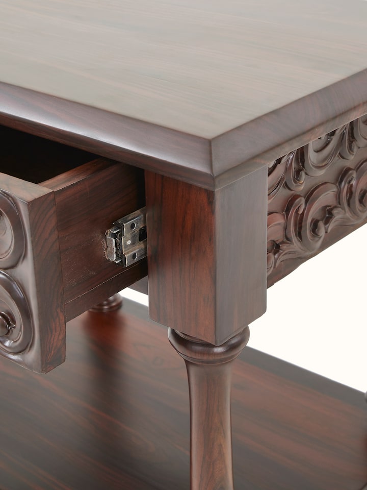 Front view showing the carved rosewood bedside table with its elegant legs and detailed work.