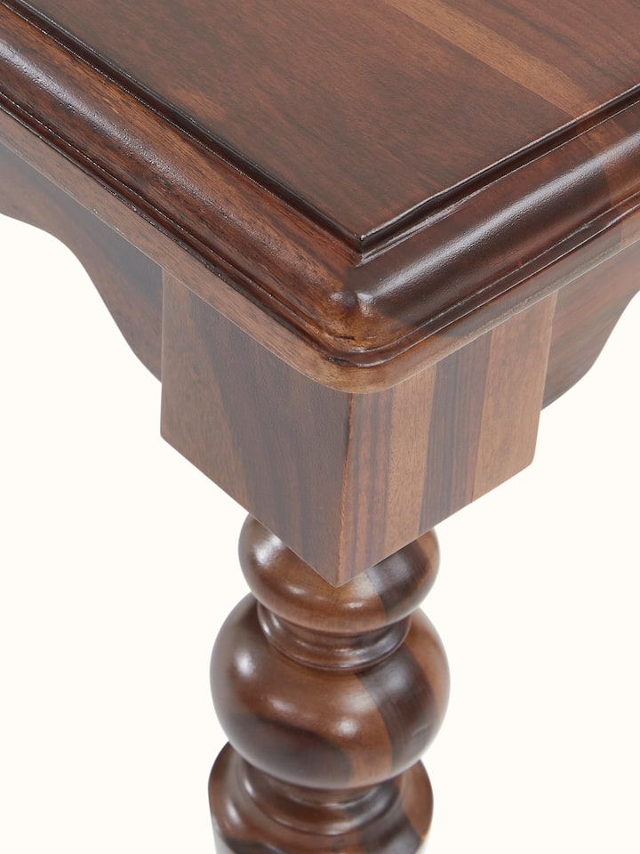Angled view of the Sheesham wood bench, showing the bench’s profile and structural details.