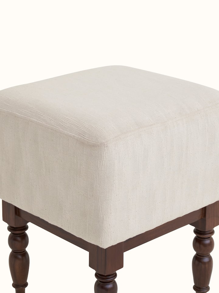 Corner view of the upholstered Sheesham wood octagonal ottoman, highlighting the seamless design and craftsmanship.