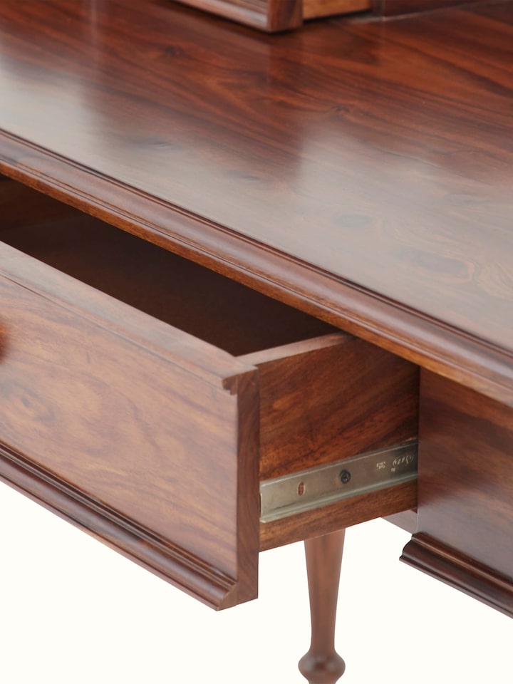 Close-up of the Sheesham wood study table's legs and base, showcasing the detailed craftsmanship