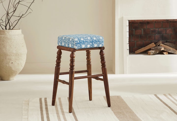Side view of the Sheesham wood Sanganeri block print bar stool, highlighting the block print pattern on the seat and the sturdy wood frame.