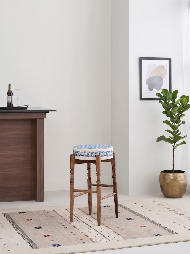 Side view of Sheesham wood bar stool with Sanganeri block print seat, highlighting the round design and detailed print.