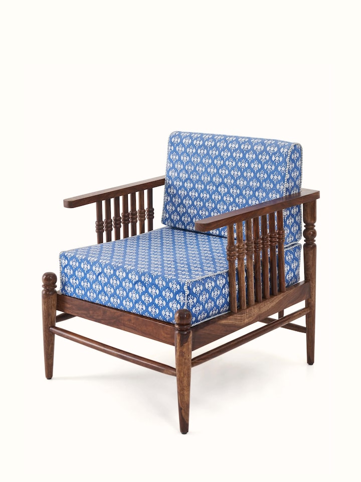 Angled view of Upholstered Sheesham Wood Sanganeri Block Print Lounge Chair highlighting its plush upholstery and sleek wooden frame.