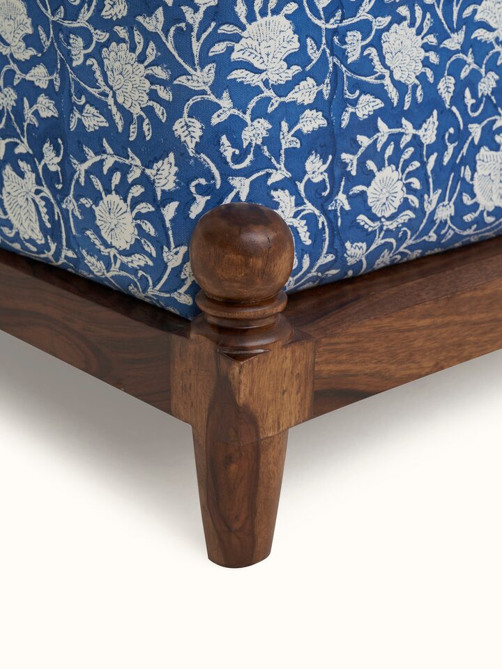 Detailed side view of Upholstered Sheesham Wood Sanganeri Block Print Pouffe, highlighting the quality of Sheesham wood and block print fabric